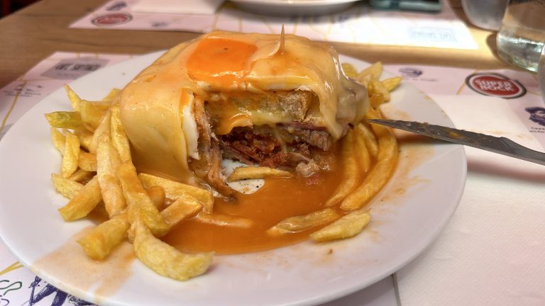 francesinha abierta con carne, queso y salsa típica de Oporto